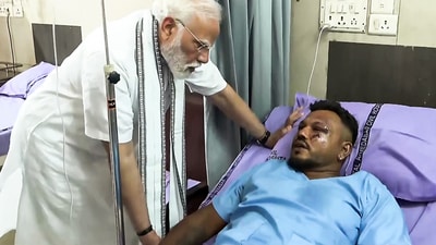 Prime Minister Narendra Modi meets and enquires about the health condition of Viswash Kumar Ramesh, the lone survivor of the Air India AI-171 flight crash, at a hospital in Ahmedabad on Friday. (ANI Photo)