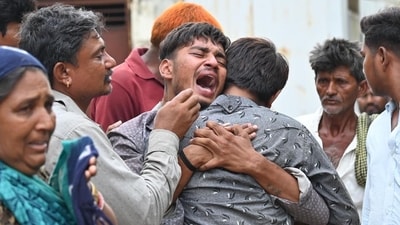 Relatives of 15-year-old Akash Patni, who was one of the people killed on the ground in the AI-171 crash, mourn outside Civil Hospital in Ahmedabad. (Raju Shinde/HT)
