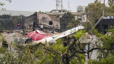 Remains of the crashed Air India plane lie on a building in Ahmedabad. (PTI)