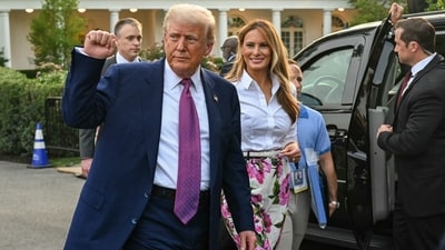 US President Donald Trump (L) raises a fist next to US First Lady Melania Trump during the Congressional Picnic on the South Lawn of the White House in Washington, DC, on June 12, 2025. (Photo by SAUL LOEB / AFP) (AFP) US President Donald Trump (L) raises a fist next to US First Lady Melania Trump during the Congressional Picnic on the South Lawn of the White House in Washington, DC, on June 12, 2025. (Photo by SAUL LOEB / AFP) (AFP)