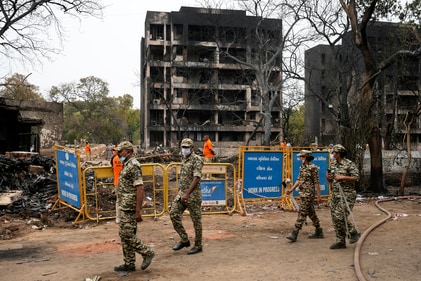 Security personnel patrol the site of an Air India plane crash in Ahmedabad (AP) Security personnel patrol the site of an Air India plane crash in Ahmedabad (AP)