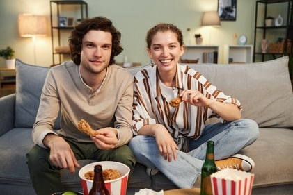 Binge eating junk food in front of TV is a common habit during weekend. (Shutterstock)