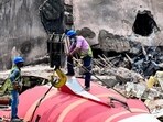 A crane lifts the wreckage of the crashed Air India plane from the roof of BJ Medical College mess on Saturday. (Raju Shinde/HT) A crane lifts the wreckage of the crashed Air India plane from the roof of BJ Medical College mess on Saturday. (Raju Shinde/HT)
