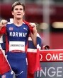Jakob Ingebrigtsen of Norway drapes himself with the national flag after winning gold medal at Tokyo Olympics. (REUTERS)