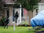 Officers canvas the neighborhood after what police said was a targeted shooting in the area around Edinburgh Golf Course in the Minneapolis suburb of Brooklyn Park, Minnesota.