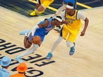 Oklahoma City Thunder guard Shai Gilgeous-Alexander (2) drives past Indiana Pacers center Myles Turner (33) during the second half of Game 4 of the NBA Finals basketball series, Friday, June 13, 2025, in Indianapolis. (AP Photo/Michael Conroy)