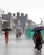People walk with umbrellas during the rain at The Ridge in Shimla on Friday. (Deepak Sansta/HT) People walk with umbrellas during the rain at The Ridge in Shimla on Friday. (Deepak Sansta/HT)