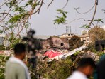 Remains of the crashed Air India plane lie on a building, in Ahmedabad, Saturday, June 14. Remains of the crashed Air India plane lie on a building, in Ahmedabad, Saturday, June 14.