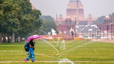 A young woman carries an umbrella to shield herself from the scorching sun during a summer morning, at a lawn along Kartavya Path, in New Delhi. (PTI) A young woman carries an umbrella to shield herself from the scorching sun during a summer morning, at a lawn along Kartavya Path, in New Delhi. (PTI)