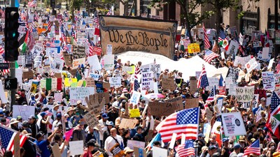 Demonstrators march in the "No Kings" protest with a U.S. Constitution sign in Los Angeles on Saturday, June 14, 2025. (AP Photo/Noah Berger) (AP) Demonstrators march in the "No Kings" protest with a U.S. Constitution sign in Los Angeles on Saturday, June 14, 2025. (AP Photo/Noah Berger) (AP)