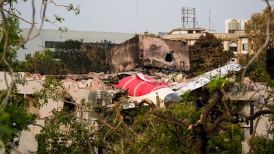 Remains of the crashed Air India plane lie on a building, in Ahmedabad, Saturday, June 14, 2025. (PTI) Remains of the crashed Air India plane lie on a building, in Ahmedabad, Saturday, June 14, 2025. (PTI)