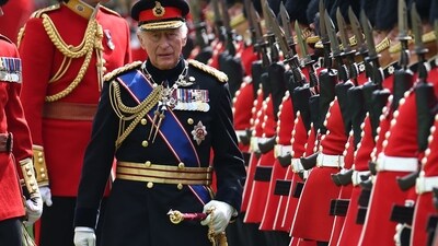 Britain's King Charles III, Colonel in Chief of the Coldstream Guards inspects the regiment during a ceremony where he presents new Colours to the 1st and 2nd Battalion (Number 7 Company) the Coldstream Guards at Windsor Castle, west of London, on June 13, 2025. One of the new Colours will be carried by Number 7 Company in the Trooping of the Colour at The King's Birthday Parade in London on Saturday June 14, 2025. (Photo by HENRY NICHOLLS / POOL / AFP) (AFP)