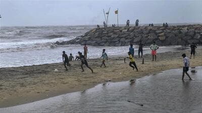 Children play football at Kothi Beach after rain stopped during monsoon season, in Kozhikode, Kerala, on May 27. (PTI) Children play football at Kothi Beach after rain stopped during monsoon season, in Kozhikode, Kerala, on May 27. (PTI)