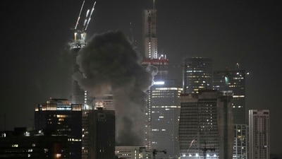 Smoke billows after a projectile hit a building in Tel Aviv after Iran launched multiple waves of missile attacks on Saturday. (AP) Smoke billows after a projectile hit a building in Tel Aviv after Iran launched multiple waves of missile attacks on Saturday. (AP)