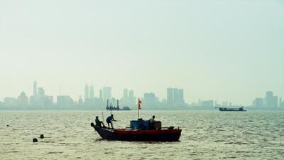Mumbai, Maharashtra, India - 09/03/2015 : Taken this picture off the city of Mumbai of a fishing trawler fishing in mid afternoon. Tried to capture the fishing activities off the coast of Mumbai and cityscape in background. (Getty Images)