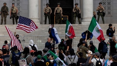 Sheriff deputies stand guard as demonstrators gather on the steps of City Hall as protests continue in response to federal immigration operations in Los Angeles on June 13, 2025. (Photo by ETIENNE LAURENT / AFP) (AFP) Sheriff deputies stand guard as demonstrators gather on the steps of City Hall as protests continue in response to federal immigration operations in Los Angeles on June 13, 2025. (Photo by ETIENNE LAURENT / AFP) (AFP)