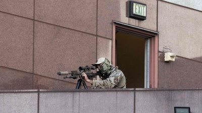 An Immigration and Customs Enforcement (ICE) Special Response Team (SRT) sniper looks through his scope as protests continue in response to federal immigration operations at the Metropolitan Detention Center in Los Angeles on June 13, 2025. (AFP) An Immigration and Customs Enforcement (ICE) Special Response Team (SRT) sniper looks through his scope as protests continue in response to federal immigration operations at the Metropolitan Detention Center in Los Angeles on June 13, 2025. (AFP)
