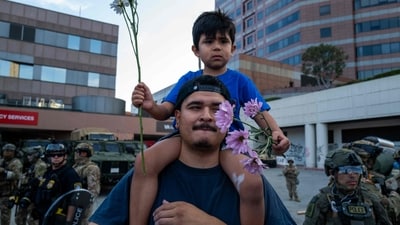 A family, protesting, confronts law enforcement outside of a federal building and Immigration and Customs Enforcement (ICE) detention center on June 13, 2025, in Los Angeles, California. (Getty Images via AFP) A family, protesting, confronts law enforcement outside of a federal building and Immigration and Customs Enforcement (ICE) detention center on June 13, 2025, in Los Angeles, California. (Getty Images via AFP)