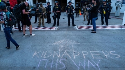 Protesters writes ‘kidnappers this way’ om road as they confronts law enforcemnet officials. (Getty Images via AFP) Protesters writes ‘kidnappers this way’ om road as they confronts law enforcemnet officials. (Getty Images via AFP)