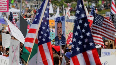 A demonstrator carries a placard with a cartoon depicting U.S. Senator Alex Padilla (D-CA), who was detained and removed from the venue after he attempted to ask a question during a press conference held by U.S. Homeland Security Secretary Kristi Noem on Thursday, during a No Kings Day protest against President Donald Trump's policies, in Los Angeles, California, U.S., June 14, 2025.  REUTERS/Mike Blake (REUTERS)