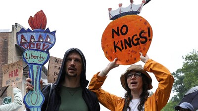 People hold signs during a No Kings Day protest against U.S. President Donald Trump's policies, in the Brooklyn borough of New York City, U.S., June 14, 2025. REUTERS/Christian Monterrosa (REUTERS)