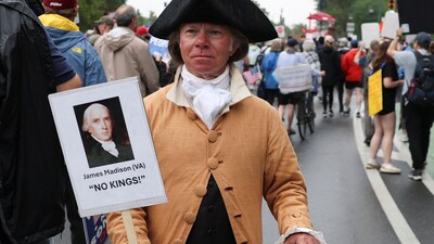 An attendee holds a placard during a No Kings Day protest against U.S. President Donald Trump's policies, in Philadelphia, Pennsylvania, U.S., June 14, 2025. REUTERS/Lee Smith (REUTERS)