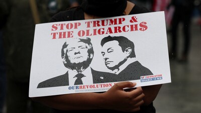 An attendee holds a placard depicting U.S. President Donald Trump and Elon Musk during a No Kings Day protest against Trump's policies, in Philadelphia, Pennsylvania, U.S., June 14, 2025. REUTERS/Lee Smith (REUTERS)
