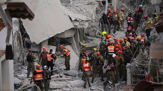 Israeli security forces inspect destroyed houses that were struck by a missile fired from Iran, in Rishon Lezion, Israel on Saturday, June 14, 2025.(Ohad Zwigenberg/AP)