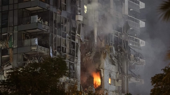 ire and smoke rise from a building, reportedly hit by a missile fired from Iran, in central Tel Aviv on June 13, 2025. Iran fired a barrage of ballistic missiles at Israel in a counter-strike in the evening on June 13, after an unprecedented onslaught hammered the Islamic republic's top military brass and targeted its nuclear facilities and bases.(Jack Guez/AFP)