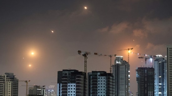 This picture shows rocket trails in the sky above Netanya on June 13, 2025. Air raid sirens sounded in Jerusalem and loud blasts were heard, AFP journalists reported, as the Israeli military said it had detected a missile launched from Iran.(Jack Guez/AFP)