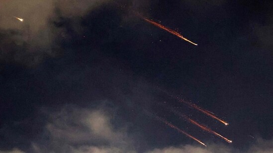 This picture shows rocket trails in the sky above Netanya on June 13, 2025.(AFP)
