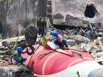 The wreckage of the crashed Air India plane is being lifted by a crane from the roof of the BJ Medical College mess building. The wreckage of the crashed Air India plane is being lifted by a crane from the roof of the BJ Medical College mess building.