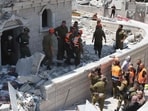 Members of the search and rescue team check the rubble of a damaged building in the northern Israeli town of Tamra, following an overnigh missile attack from Iran on June 15, 2025, 