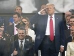 President Donald Trump salutes as attends a military parade commemorating the Army’s 250th anniversary, coinciding with his 79th birthday, Saturday, June 14, 2025, in Washington, as Secretary of the Army Daniel Driscoll, Defense Secretary Pete Hegseth, and first lady Melania Trump, watch. (AP Photo/Julia Demaree Nikhinson)