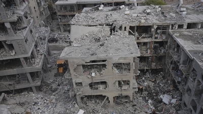 Israeli first responders work in a residential area hit by a missile fired from Iran, near Tel Aviv, Israel, Sunday, June 15, 2025. (AP Photo/Ariel Schalit) Israeli first responders work in a residential area hit by a missile fired from Iran, near Tel Aviv, Israel, Sunday, June 15, 2025. (AP Photo/Ariel Schalit)