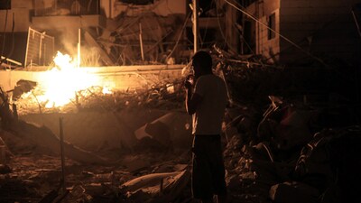 A man smokes next to an impact site following missile attack from Iran on Israel, at central Israel June 15, 2025. (Itai Ron/REUTERS)