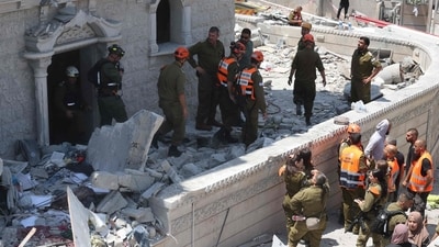 Members of the search and rescue team check the rubble of a damaged building in the northern Israeli town of Tamra, following an overnigh missile attack from Iran on June 15, 2025, (AFP) Members of the search and rescue team check the rubble of a damaged building in the northern Israeli town of Tamra, following an overnigh missile attack from Iran on June 15, 2025, (AFP)