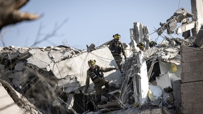 Israeli emergency responders inspect a site hit by a missile fired from Iran south of Tel Aviv. (John Wessels/AFP) Israeli emergency responders inspect a site hit by a missile fired from Iran south of Tel Aviv. (John Wessels/AFP)