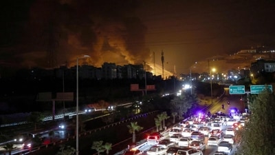 Vehicles jam a highway as a fire blazes nearby in the oil depots of Shahran, northwest of Tehran, on June 15, 2025. (Atta Kenare/AFP) Vehicles jam a highway as a fire blazes nearby in the oil depots of Shahran, northwest of Tehran, on June 15, 2025. (Atta Kenare/AFP)
