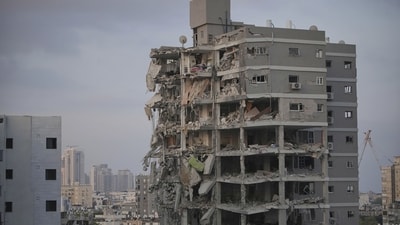 Israeli security forces inspect a destroyed building that was hit by a missile fired from Iran, near Tel Aviv. (AP Photo/Ohad Zwigenberg) Israeli security forces inspect a destroyed building that was hit by a missile fired from Iran, near Tel Aviv. (AP Photo/Ohad Zwigenberg)