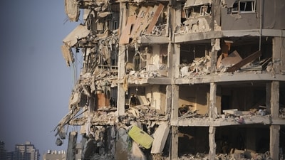 Israeli security forces inspect a destroyed building that was hit by a missile fired from Iran, near Tel Aviv. (AP Photo/Ohad Zwigenberg) Israeli security forces inspect a destroyed building that was hit by a missile fired from Iran, near Tel Aviv. (AP Photo/Ohad Zwigenberg)