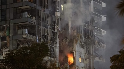 Fire and smoke rise from a building, reportedly hit by a missile fired from Iran, in central Tel Aviv. Iran fired a barrage of ballistic missiles at Israel in a counter-strike in the evening on June 13, after an unprecedented onslaught hammered the Islamic republic's top military brass and targeted its nuclear facilities and bases. (Jack Guez/AFP) Fire and smoke rise from a building, reportedly hit by a missile fired from Iran, in central Tel Aviv. Iran fired a barrage of ballistic missiles at Israel in a counter-strike in the evening on June 13, after an unprecedented onslaught hammered the Islamic republic's top military brass and targeted its nuclear facilities and bases. (Jack Guez/AFP)