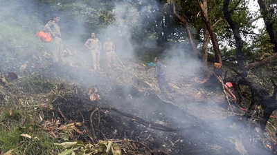 Security personnel at the spot after a helicopter crashed near the Kedarnath shrine, in Rudraprayag district. (PTI) Security personnel at the spot after a helicopter crashed near the Kedarnath shrine, in Rudraprayag district. (PTI)