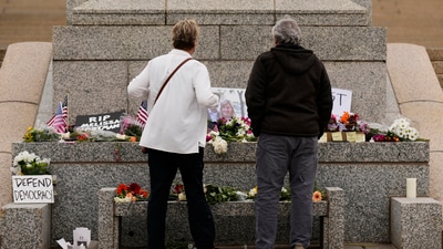 Dianne, left, and Rick (last names withheld) visit makeshift memorial for Minnesota state Rep. Melissa Hortman and her husband Mark at the state Capitol, Sunday, June 15, 2025, in St. Paul, Minn. (AP Photo/George Walker IV) (AP) Dianne, left, and Rick (last names withheld) visit makeshift memorial for Minnesota state Rep. Melissa Hortman and her husband Mark at the state Capitol, Sunday, June 15, 2025, in St. Paul, Minn. (AP Photo/George Walker IV) (AP)