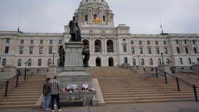 People visit a makeshift memorial for Minnesota state Rep. Melissa Hortman and her husband Mark at the state Capitol, Sunday, June 15, 2025, in St. Paul, Minn. (AP Photo/George Walker IV) (AP) People visit a makeshift memorial for Minnesota state Rep. Melissa Hortman and her husband Mark at the state Capitol, Sunday, June 15, 2025, in St. Paul, Minn. (AP Photo/George Walker IV) (AP)