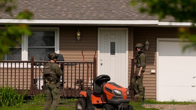 Members of law enforcement search for shooting suspect, Vance Boelter, at a house Sunday, June 15, 2025, in Belle Plaine, Minn. (AP Photo/George Walker IV) (AP) Members of law enforcement search for shooting suspect, Vance Boelter, at a house Sunday, June 15, 2025, in Belle Plaine, Minn. (AP Photo/George Walker IV) (AP)