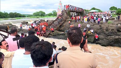 National Disaster Response Force (NDRF) personnel conduct a rescue operation, after a bridge collapsed on the Indrayani River, near Kundamala village. (ANI)