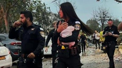 Policewoman Aviv Sarga, while rescuing a baby from the rubble. (X/Israel Police) Policewoman Aviv Sarga, while rescuing a baby from the rubble. (X/Israel Police)