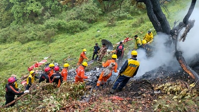 NDRF and SDRF personnel at the spot after a helicopter crashed near the Kedarnath shrine, in Rudraprayag district, Uttarakhand, Sunday, June 15. (NDRF) NDRF and SDRF personnel at the spot after a helicopter crashed near the Kedarnath shrine, in Rudraprayag district, Uttarakhand, Sunday, June 15. (NDRF)