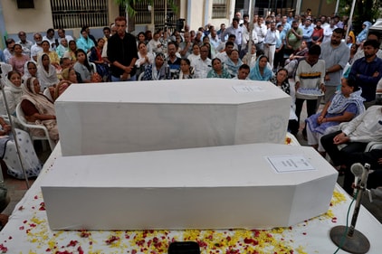 People pay their respects next to the coffins containing the remains of Rozar David Christian and his wife Rachnaben Rozar Christian, who lost their lives in an Air India Boeing 787-8 Dreamliner plane crash (REUTERS)